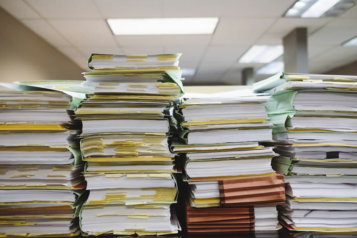 Tall stacks of paper files and folders