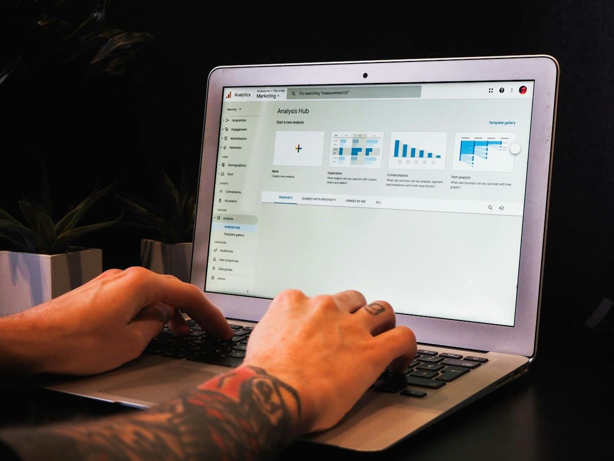Hands typing on a laptop at a desk