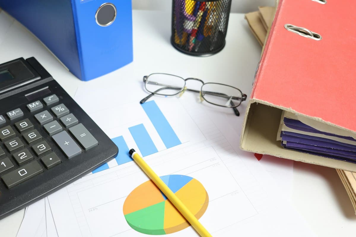 Charts, a calculator and folders on a desk