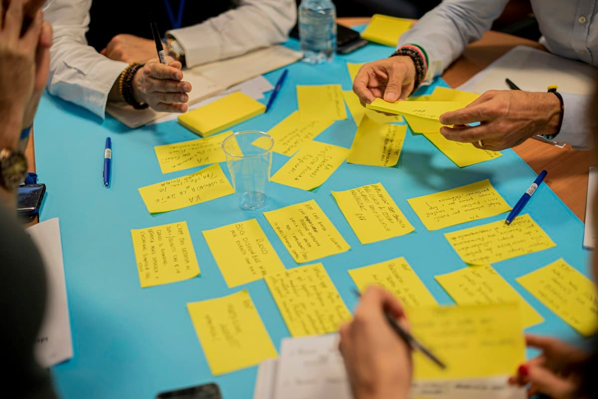 A team sorting sticky notes on a table