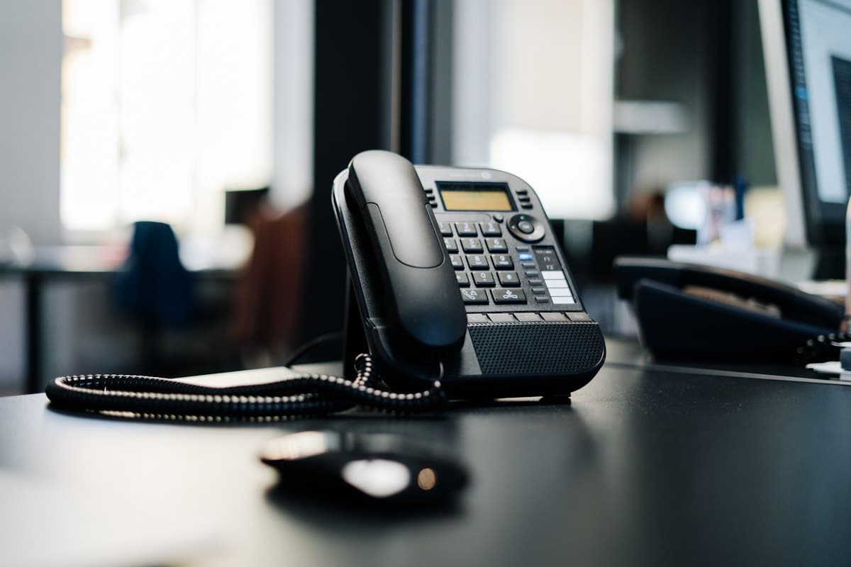 A desk phone in an empty office