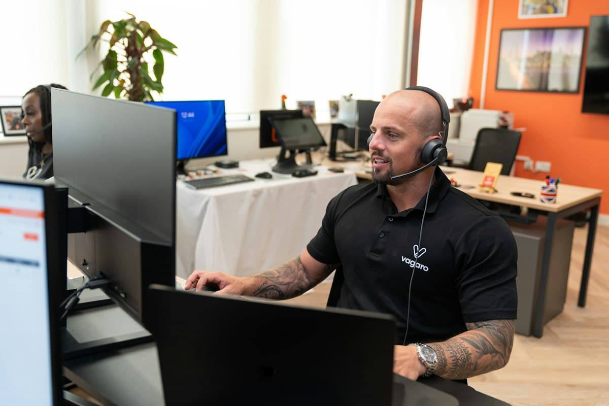A man in a headset working at a computer